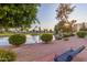 Relaxing pond-side view with a park bench, offering a peaceful outdoor space at 7930 E Camelback Rd # 506, Scottsdale, AZ 85251