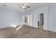 Well-lit bedroom featuring carpet and staircase view at 44263 W Palmen Dr, Maricopa, AZ 85138