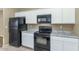 Modern kitchen with white cabinets and black appliances at 30200 N Desert Willow Blvd, San Tan Valley, AZ 85143