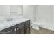 Bathroom features dark brown vanity and a shower/tub combo at 30200 N Desert Willow Blvd, San Tan Valley, AZ 85143