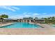Inviting community pool with lounge chairs and covered areas at 30200 N Desert Willow Blvd, San Tan Valley, AZ 85143