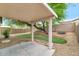 Covered patio overlooking the grassy backyard with large tree at 30200 N Desert Willow Blvd, San Tan Valley, AZ 85143