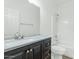 Bathroom with dark brown vanity and a shower/tub combo at 30200 N Desert Willow Blvd, San Tan Valley, AZ 85143