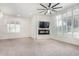 Bright living room featuring a built-in fireplace and large windows at 1920 E Schooner Ct, Gilbert, AZ 85234