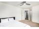 Comfortable bedroom with ceiling fan and access to hallway at 1920 E Schooner Ct, Gilbert, AZ 85234