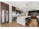 Modern kitchen with stainless steel appliances, a large island, and dark wood cabinetry at 1920 E Schooner Ct, Gilbert, AZ 85234