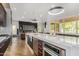 Modern kitchen with stainless steel appliances and a large island with quartz countertop at 1920 E Schooner Ct, Gilbert, AZ 85234