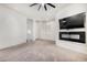 Spacious bedroom with plush carpet, fireplace, and large TV at 1920 E Schooner Ct, Gilbert, AZ 85234
