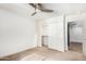 Cozy bedroom with ceiling fan and sliding door to closet at 1920 E Schooner Ct, Gilbert, AZ 85234