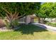 Landscaped yard with mature trees and driveway at 1920 E Schooner Ct, Gilbert, AZ 85234