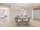 Dining area with a glass-top table and four chairs, open to living room at 11500 E Cochise Dr # 2011, Scottsdale, AZ 85259