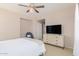 Spacious bedroom featuring a queen bed, large TV, and ample closet space at 11500 E Cochise Dr # 2011, Scottsdale, AZ 85259