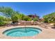 Community hot tub with surrounding lounge chairs at 11500 E Cochise Dr # 2011, Scottsdale, AZ 85259