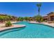 Community swimming pool with palm trees and seating at 11500 E Cochise Dr # 2011, Scottsdale, AZ 85259