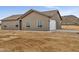 Single story home with attached garage and neutral color exterior at 22329 W Gamble Ln, Wittmann, AZ 85361