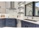 Modern kitchen with white and navy cabinets, herringbone tile backsplash, and a farmhouse sink at 6832 E Stevens Rd, Cave Creek, AZ 85331