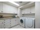 Laundry room with washer, dryer, and ample cabinet space at 9673 E Oberlin Way # 15, Scottsdale, AZ 85262