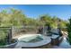 Private hot tub with ornate railing, surrounded by desert landscaping at 9673 E Oberlin Way # 15, Scottsdale, AZ 85262