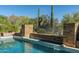 Relaxing pool area with stone accents and desert landscape at 9673 E Oberlin Way # 15, Scottsdale, AZ 85262