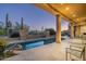 Resort-style backyard with a large pool and spa, surrounded by a beautifully landscaped patio at 9673 E Oberlin Way # 15, Scottsdale, AZ 85262