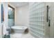 Spa-like bathroom featuring a soaking tub and glass block shower at 9673 E Oberlin Way # 15, Scottsdale, AZ 85262