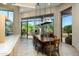 Formal dining room with large windows and a beautiful wood table at 9673 E Oberlin Way # 15, Scottsdale, AZ 85262