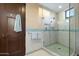 Bathroom with a walk-in shower and dark wood door at 9673 E Oberlin Way # 15, Scottsdale, AZ 85262