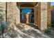Stunning stone exterior with a grand entrance and arched entryway at 9673 E Oberlin Way # 15, Scottsdale, AZ 85262