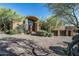 Luxury home with a stone facade and a paved driveway at 9673 E Oberlin Way # 15, Scottsdale, AZ 85262