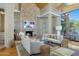 Spacious living room with a stone fireplace, hardwood floors, and ample natural light at 9673 E Oberlin Way # 15, Scottsdale, AZ 85262