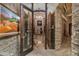 Elegant wine cellar with stone walls and extensive wine storage at 9673 E Oberlin Way # 15, Scottsdale, AZ 85262