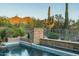 Expansive pool and spa area with stone accents and desert landscape views at 9673 E Oberlin Way # 15, Scottsdale, AZ 85262