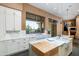 Spacious kitchen boasts an island, marble countertops, and a large window at 9673 E Oberlin Way # 15, Scottsdale, AZ 85262