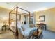 Primary bedroom with four-poster bed and sitting area at 9673 E Oberlin Way # 15, Scottsdale, AZ 85262