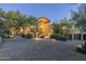 Luxury home with stone facade, expansive driveway, and desert landscaping at 9673 E Oberlin Way # 15, Scottsdale, AZ 85262