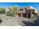 Two-car garage with wooden doors and stone accents at 9673 E Oberlin Way # 15, Scottsdale, AZ 85262