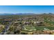 Expansive aerial view showcasing a luxurious community near a golf course and mountain backdrop at 9673 E Oberlin Way # 15, Scottsdale, AZ 85262