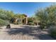 Luxury home with a stone facade and a paved driveway at 9673 E Oberlin Way # 15, Scottsdale, AZ 85262