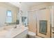 Bathroom with shower/tub combo, vanity, and window at 9901 W Desert Forest Cir, Sun City, AZ 85351