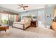 Bright bedroom with a king-size bed, private bath access, and backyard views at 6964 E Redbird Rd, Scottsdale, AZ 85266