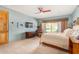 Spacious bedroom with wood floors, ceiling fan, and access to a private patio at 6964 E Redbird Rd, Scottsdale, AZ 85266