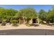 Landscaped front yard with mature trees and a welcoming entryway at 6964 E Redbird Rd, Scottsdale, AZ 85266