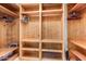 Large walk-in closet with wood shelving and hanging rods at 6964 E Redbird Rd, Scottsdale, AZ 85266