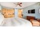 Main bedroom with built-in wood cabinets and a large flat-screen TV at 6964 E Redbird Rd, Scottsdale, AZ 85266