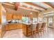 Open kitchen with granite island, wood cabinetry, and stainless steel appliances at 6964 E Redbird Rd, Scottsdale, AZ 85266