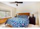 Bedroom with window seat, wood-toned nightstand, and patterned bedding at 6964 E Redbird Rd, Scottsdale, AZ 85266