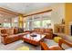 Spacious living room with leather couches and a fireplace at 6964 E Redbird Rd, Scottsdale, AZ 85266
