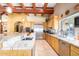 Bright kitchen with granite countertops, wood cabinetry, and stainless steel appliances at 6964 E Redbird Rd, Scottsdale, AZ 85266