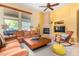 Living room with fireplace and large windows at 6964 E Redbird Rd, Scottsdale, AZ 85266