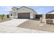 Beige one-story house with brown garage door and gravel driveway at 24003 W Mohave St, Buckeye, AZ 85326